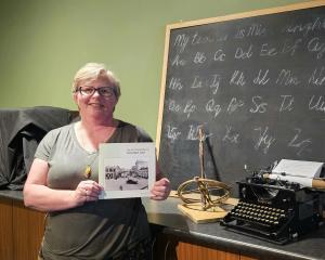 South Canterbury Museum educator Keely Kroening shows off a copy of South Canterbury: How we...