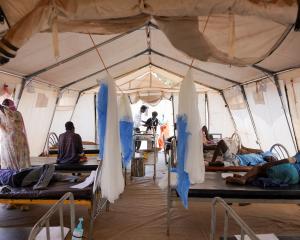 Injured displaced Sudanese people who fled violence in El Fasher receive treatment at a makeshift...