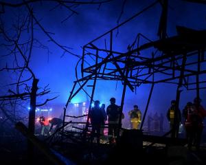 Firefighters work at the site of the Russian air strike, amid Russia's attack on Ukraine, in...