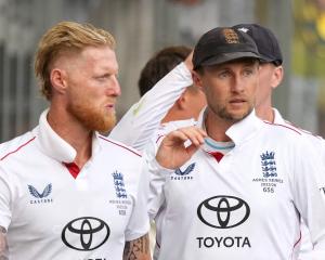 England skipper Ben Stokes (left) and Joe Root look dejected after the match. Photo: Reuters 