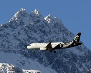 An Air New Zealand Airbus A320 plane passes the Remarkables as it heads in to land at Queenstown...