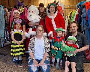 At the costume fitting for the Southland Santa Parade on this Saturday are (back, from left)...