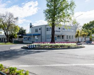 The eye-catching purple and white baby’s-breath, tulip and pansy spring flower bed, at the...