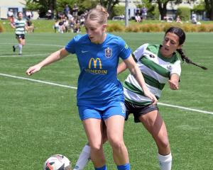 Raegan Potter controls the ball for Southern United under the pressure of Western Springs player...