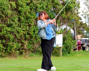 Dunedin Community House volunteer Margaretha Situmorang practises her golf swing before a...
