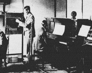 Public broadcasting begins. Operator Bill Huggins, engineer Jack Bingham and musical director and...