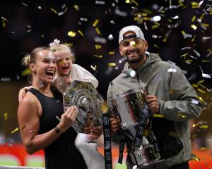 Belarus' Aryna Sabalenka, her goddaughter Nicole, and Australia's Nick Kyrgios celebrate with...