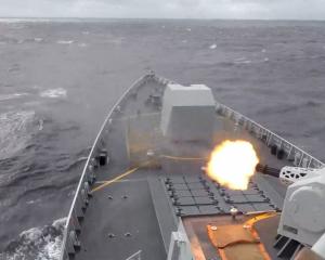 A ship fires a weapon during drills east of Taiwan, in this screenshot from a video released by...