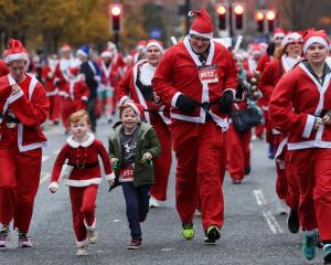 Runners take part in the annual 5km Santa Dash in Liverpool. PHOTO: REUTERS