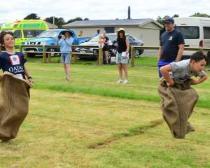 Ali Peterson, then aged 10 (right), of Riverton, jumps to a win in a sack race at the New Year’s...