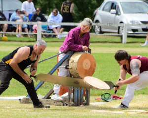 A team saw through a log at a previous Tūātapere Sports Day. Photo: Supplied / Dave Loudon