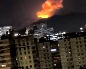 A column of smoke rises during multiple explosions in the early hours of the morning, in Caracas,...