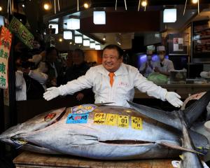Kiyomura Co President Kiyoshi Kimura poses with a 243kg bluefin tuna sold at auction for a record...