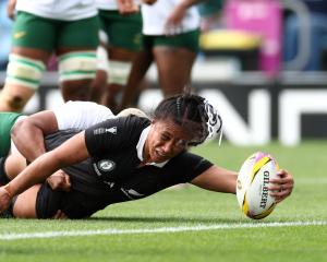 Black Ferns forward Liana Mikaele-Tu’u reaches for the line after being tackled by South African...
