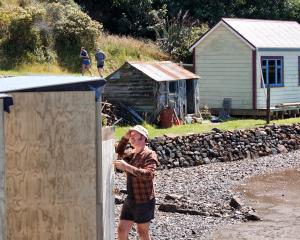 New owner Wade Nicholson works on a shed at the historic Deborah Bay Lewis Cottage which he...
