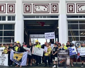 Firefighters gather outside the Central Dunedin Fire Station yesterday as they again went on...