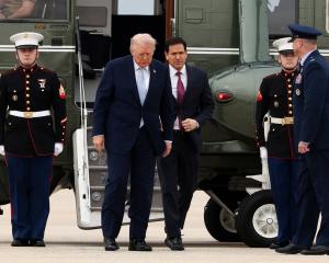 US President Donald Trump and Secretary of State Marco Rubio step out from Marine One to board...