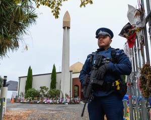 An armed police officer guarding Al Noor Mosque in 2019. Photo: Getty Images