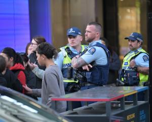 Police keep an eye on the group of young people in George St this afternoon. PHOTO: GERARD O'BRIEN