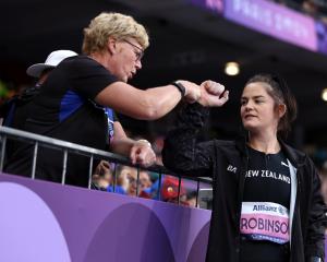 Raylene Bates (left), pictured with thrower Holly Robinson, was Team New Zealand chef de mission...