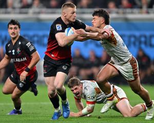 Crusaders winger Johnny McNicholl runs the ball up against the Chiefs. Photo: Getty Images