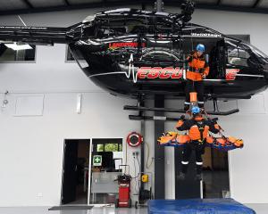 Winch operator Maddy Burns practises her skills with critical care paramedic Anthony Hoets in...