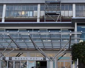 Work on repairing windows on the frontage of Dunedin’s Moana Pool yesterday. PHOTO: PETER MCINTOSH