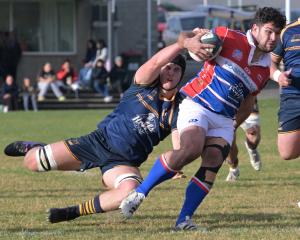Dunedin lock Alex Arnold attempts to drag down Harbour hooker Gabriel Francesconi during their...