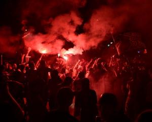 Paris Saint-Germain (PSG) supporters clash with police during celebrations following the team's...