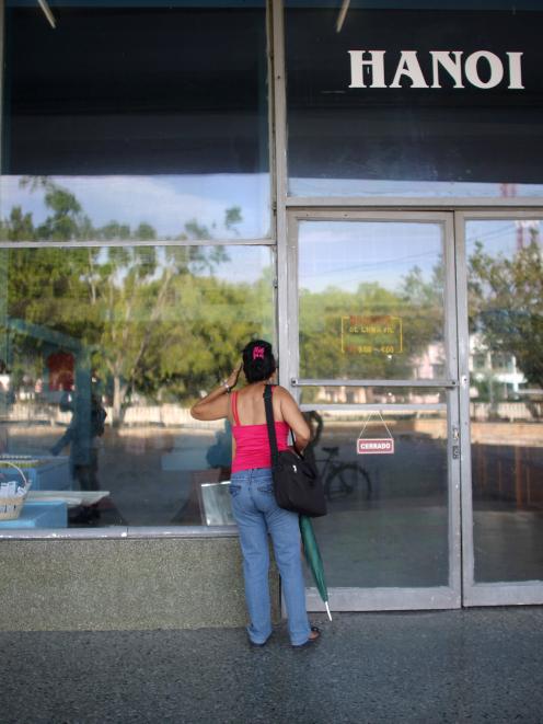 A woman looks into a store in Holguin, Cuba's fourth largest city. Photo: Reuters 