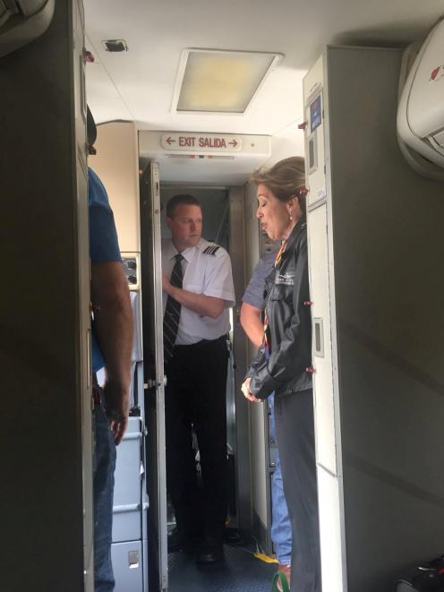 Pilot Tammie Jo Schults (right) and cabin crew after making a safe landing. Photo: Kristopher...
