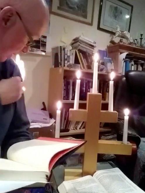 Vicar Stephen Beach reacts as his jersey catches fire while delivering a video sermon. Photo: St...