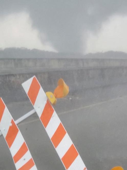 A tornado passes a highway in New Iberia, Louisiana. Photo: Mike Ibert/via Reuters