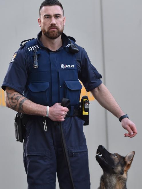 Constable Regan Mauheni and his 10-month-old German Shepherd pup Paikea. Photo: Peter McIntosh.