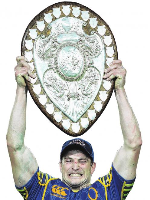 Otago captain Paul Grant holds aloft the Ranfurly Shield after helping his side defeat Waikato 26...