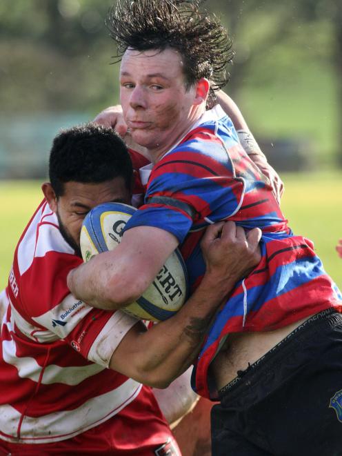 Owaka’s Jack Holland-Spinks is tackled by Clutha’s Robin Fesilafai during the ...