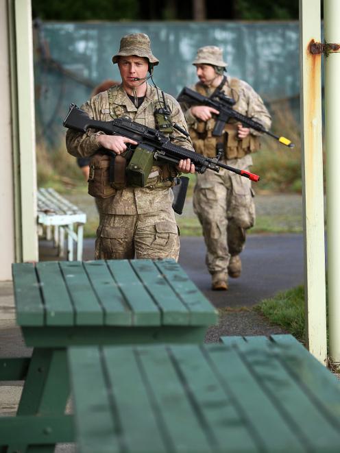 NZ Army Reserve Force soldiers from Invercargill and Cromwell clear the clubhouse at the vacant...