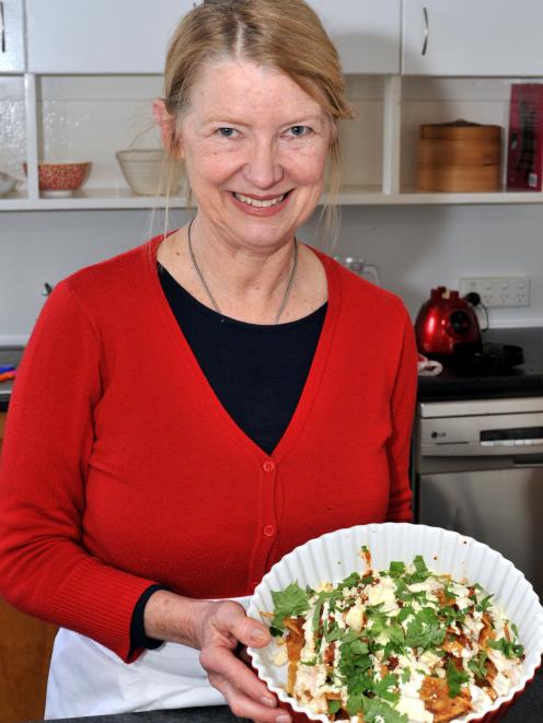 Courtney Campbell, born in Mexico City,holds a dish of  chilaquiles. Photo: Gregor Richardson.