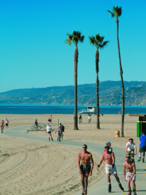 Visitors soak up the sun on the South Bay bicycle trail, on Santa Monica beach. Photo from Santa Monica Convention and Visitors Bureau