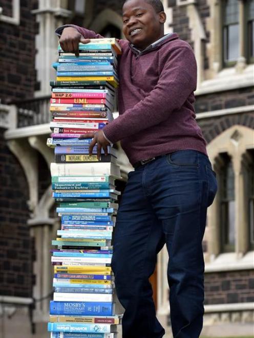 Felix Bello with some of the textbooks he has been given to take back to his home university in Malawi. Photo by Gregor Richardson