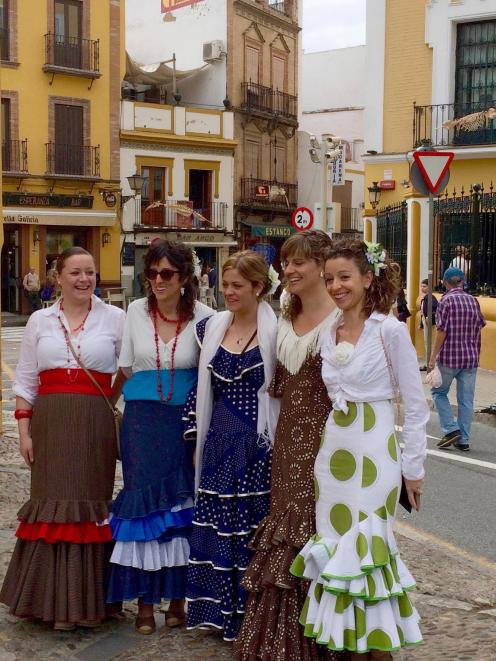 After a night at the Feria, most Sevillanos parade their beautiful costumes on the streets on...