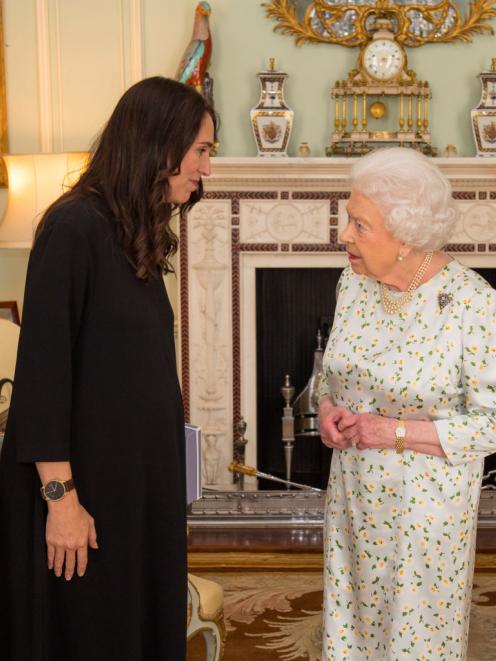 Prime Minister of New Zealand Jacinda Ardern is greeted by Queen Elizabeth II during a private...