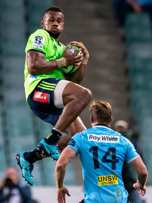 Tevita Nabura takes the ball before kicking Waratahs player Cameron Clark. Photo: Getty Images