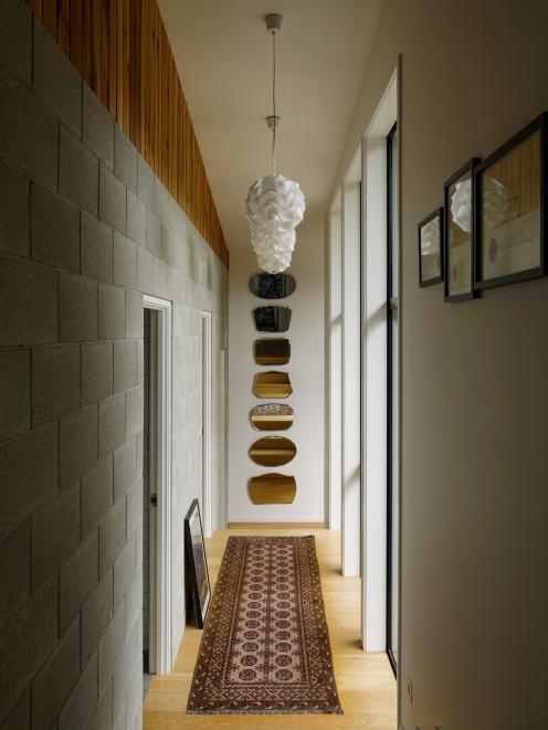 In winter, this masonry block wall captures and stores heat from the sun. The house also has...