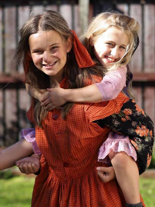 Cassidy Hartley-Brown, who plays orphan Duffy, piggybacks Izzy Madden (Molly) at a recent...