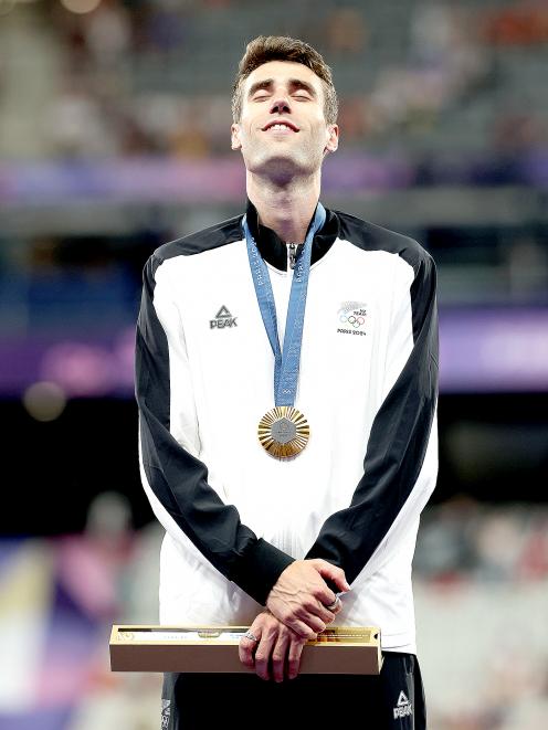 Hamish Kerr soaks it in on the Olympic podium. Photo: Getty Images