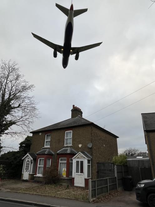 Planes pass low overhead on their flight path into Heathrow Airport.