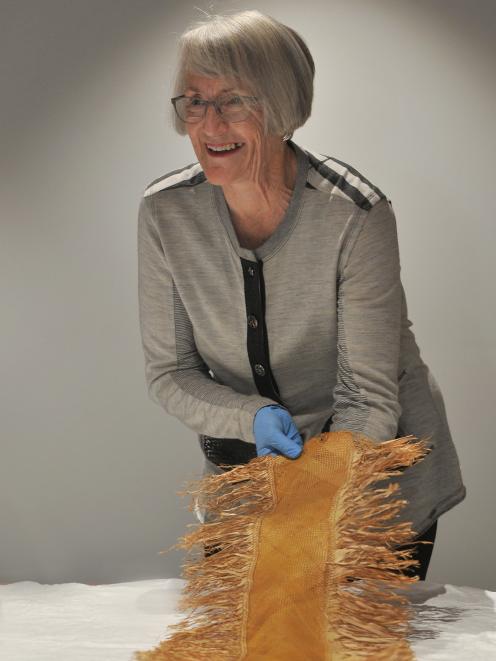 Mary Gray has her first view of Polynesian textile items found by her grandfather in a cave near...