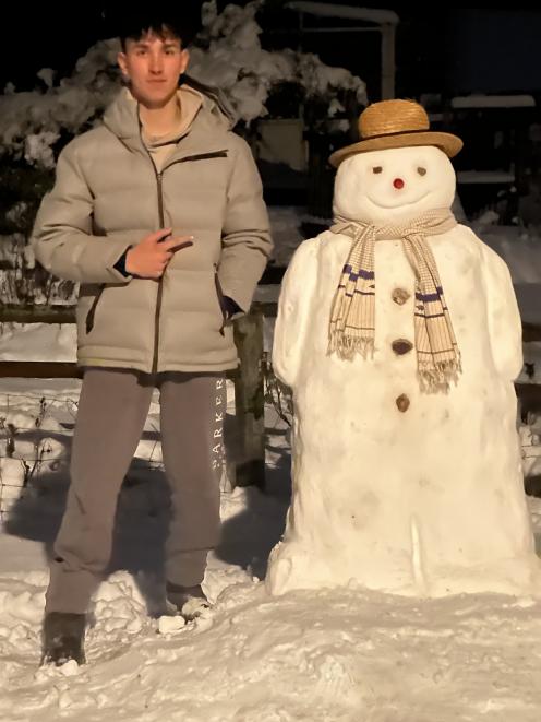 Shaun Thomson with a snowman in Naseby, Central Otago, on Saturday night. Photo: supplied 