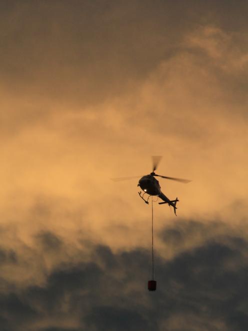 Helicopters with monsoon buckets were called in late afternoon. Photo: Hamish MacLean 